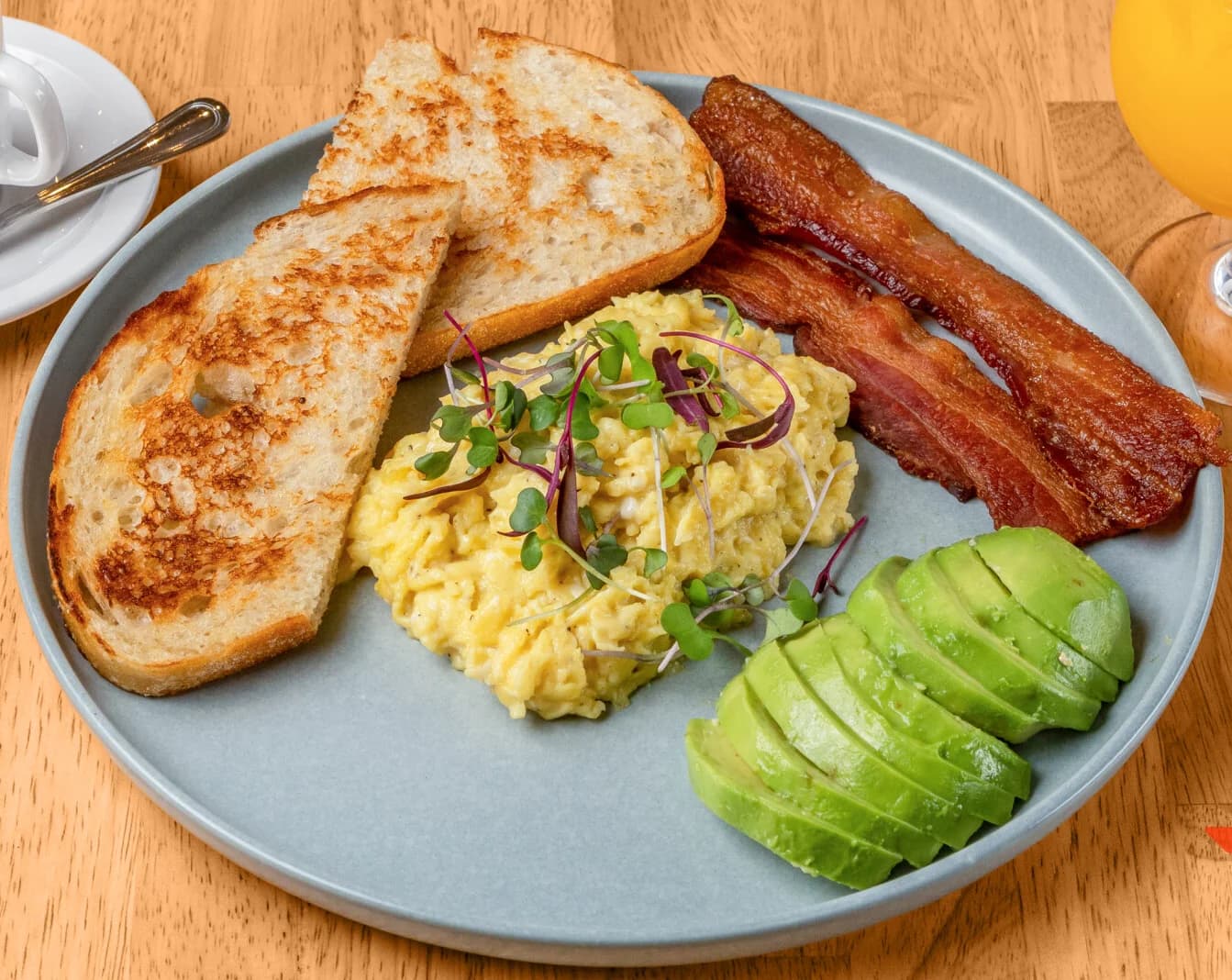 Floré breakfast with eggs, artisan bread, bacon and avocado