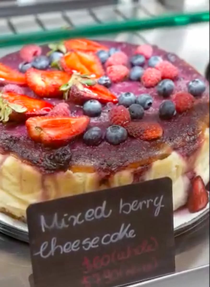 Mixed berry cheesecake displayed at Floré Café & Kitchen